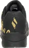 The back view of a black and gold SKECHERS sports shoe. Voir les images du produit