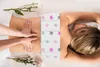 A person receiving a massage with a heat pack on their lower back. Produktbild-Vorschau