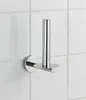 A chrome toilet paper roll holder mounted on a white tiled wall. Produktbild-Vorschau