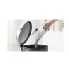 A hand empties a dustbin from a vacuum cleaner into a larger bin. Náhled obrázku produktu