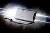 A silver power bank with a digital display showing '90%' is illuminated by bright, blue light beams emanating from its side, set against a dark, smoky background. Produktbild-Vorschau