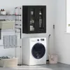 A laundry room scene with a washing machine, drying rack, and wall cabinet.