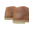 A close-up view of the back of two brown leather desert boots. Náhled obrázku produktu