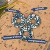 Three bird feeder rings arranged in a triangular pattern on a burlap background with scattered seeds. Produktbild-Vorschau