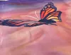 A close-up of a fabric with a butterfly print. Produktbild-Vorschau