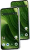 Two smartphones are displayed diagonally against a white background, showcasing their green wallpaper and white frames with yellow accents. Produktbild-Vorschau