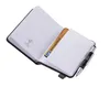 An open notebook with a card and a pen inserted. Produktbild-Vorschau