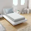 A bed with a mattress topper and pillow in a bright room. Náhled obrázku produktu