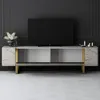 A modern TV stand with a television on top, placed against a dark paneled wall. Voir les images du produit