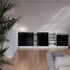A modern living room with a set of black and white cabinets against a light gray wall. Podgląd zdjęcia produktu