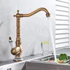 A vintage-style brass faucet with water running into a sink with vegetables. Náhľad obrázku produktu
