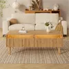 A living room scene with a couch, coffee table, and rug. Produktbild-Vorschau