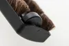A close-up shot of a vacuum cleaner brush attachment, focusing on the bristles and a small black roller. Produktbild-Vorschau
