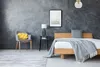 A bedroom scene with a bed, chair, and nightstand. Voir les images du produit