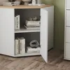 A white kommode with a wood-tone top, open doors revealing shelves with books and decorative items, set against a light gray and green background. Anteprima dell’immagine prodotto