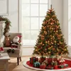 A decorated Christmas tree with presents underneath, a chair with stuffed figures, and a garland on a mantelpiece. Anteprima dell’immagine prodotto