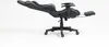 A black and gray gaming chair with a footrest extended, shown from the side against a white background. Produktbild-Vorschau
