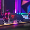 A close-up shot of a computer RAM module with RGB lighting, installed on a motherboard. Produktbild-Vorschau