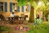 A family enjoying a meal and relaxing in a garden setting. Náhled obrázku produktu