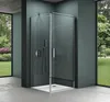 A modern shower cabin with glass doors and a silver shower fixture, set against a dark teal wall and a concrete floor. Large windows on the left and right reveal a lush green garden. Produktbild-Vorschau