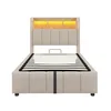 A beige upholstered bed frame with a slatted mattress base and a wooden headboard with integrated LED lighting. Náhled obrázku produktu