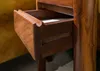 A close-up view of an open wooden drawer on a piece of furniture. Anteprima dell’immagine prodotto
