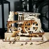 A wooden marble run model kit with several marbles on a sandy surface. Podgląd zdjęcia produktu