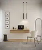 A minimalist home office setup with a floating desk, laptop, chair, and decorative items. Anteprima dell’immagine prodotto
