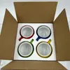 Four colorful ceramic mugs are packed in a cardboard box with foam inserts. Voir les images du produit