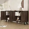 A dark wood sideboard with its doors open, displaying books and decorative items, in a well-lit room with a plant and wall art. Produktbild-Vorschau