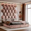 A modern bedroom with a large upholstered headboard and a bed. Anteprima dell’immagine prodotto