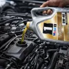Pouring oil into a car engine. Produktbild-Vorschau