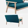 Two views of a turquoise blue two-seater sofa with wooden legs and armrests, presented on a plain white background. Anteprima dell’immagine prodotto