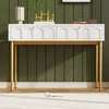 A white sideboard with gold legs against a green paneled wall. Podgląd zdjęcia produktu
