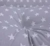 A close-up view of a gray fabric with white stars, showing the texture and pattern. Produktbild-Vorschau