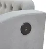 A close-up view of a gray upholstered sofa armrest with a built-in charging port. Produktbild-Vorschau