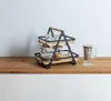 A two-tiered serving stand with glasses and jars on a wooden shelf against a tiled wall. Podgląd zdjęcia produktu