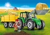 A Playmobil tractor with a trailer and a farmer in a field. Voir les images du produit