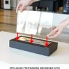 Hands are shown installing a glass panel onto a black tabletop fireplace. Náhľad obrázku produktu