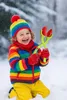 A child playing in the snow with a snowball maker. Produktbild-Vorschau