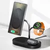 A black 3-in-1 wireless charging stand holding a smartphone, a smartwatch, and wireless earbuds. Podgląd zdjęcia produktu