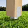 A wooden post is secured to the ground with a metal post anchor in a grassy yard. Produktbild-Vorschau