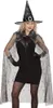 A woman wearing a witch costume, including a hat and cape, posing against a white background. Anteprima dell’immagine prodotto