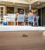 People are seated around a table on a patio, with a hot tub in the foreground. Produktbild-Vorschau