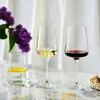 Three glasses of drinks and a purple flower arrangement on a marble surface. Produktbild-Vorschau