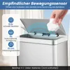 A hand is shown throwing a crumpled piece of paper into a silver automatic trash can. Podgląd zdjęcia produktu