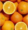 A close-up, overhead view of a pile of fresh oranges, with one orange sliced in half to reveal its juicy interior. Produktbild-Vorschau