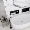 A modern bathroom with a freestanding bathtub, marble walls, and built-in shelves. Anteprima dell’immagine prodotto