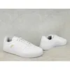 Two white Adidas sneakers are shown on a light gray concrete background. Produktbild-Vorschau