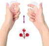 Hands holding clear plastic baubles, with an arrow indicating movement, and a finished bauble with red berries inside. Podgląd zdjęcia produktu